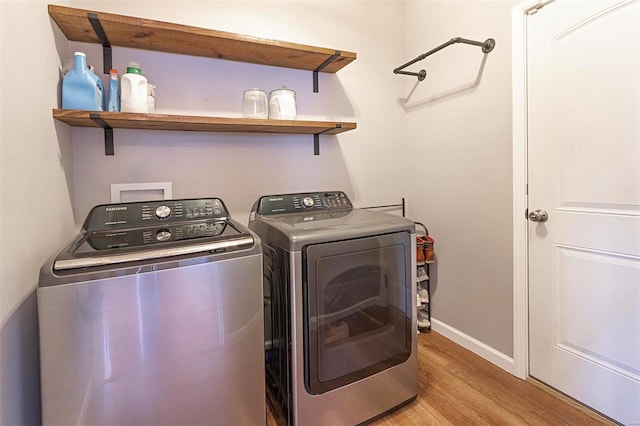 clothes washing area featuring light hardwood / wood-style flooring and independent washer and dryer