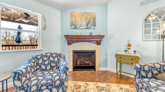 sitting room with hardwood / wood-style flooring and vaulted ceiling