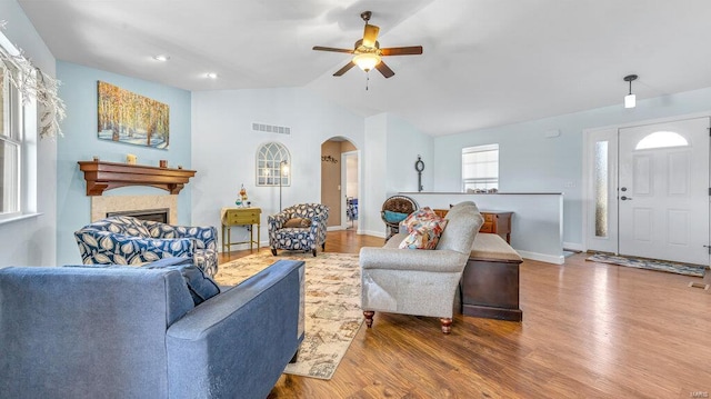 living room featuring lofted ceiling, hardwood / wood-style flooring, and ceiling fan