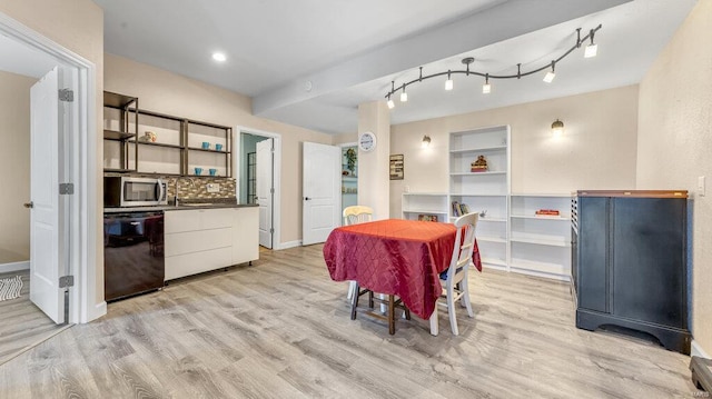 dining area with light wood-type flooring and built in features