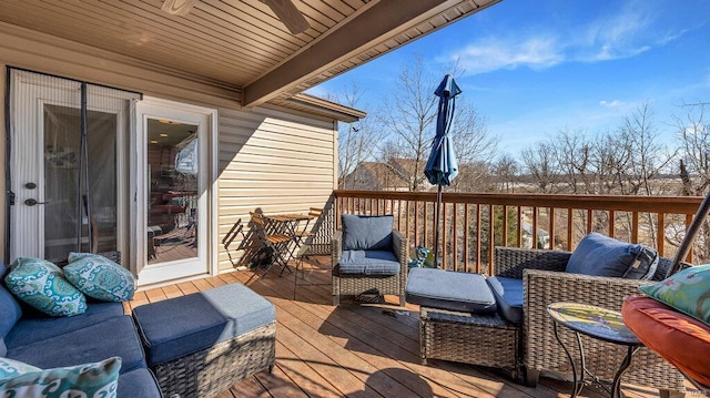 deck featuring outdoor lounge area and ceiling fan