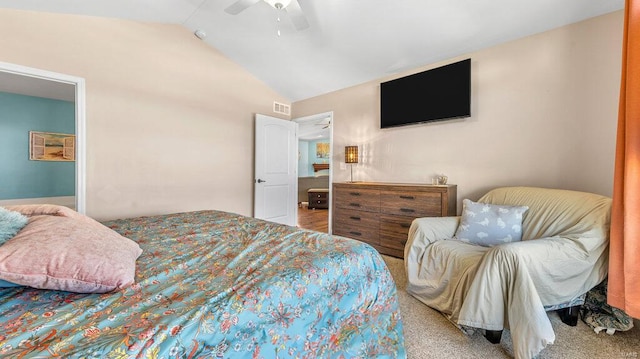 carpeted bedroom with ceiling fan and vaulted ceiling