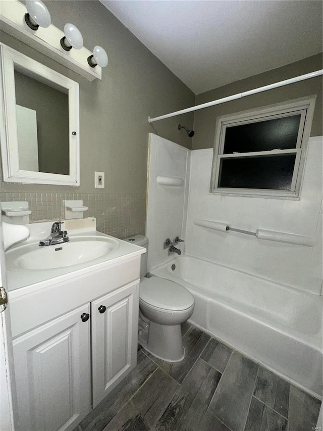 full bathroom featuring shower / tub combination, vanity, toilet, and backsplash