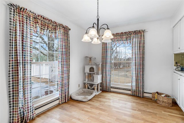 unfurnished dining area with a baseboard radiator, light hardwood / wood-style floors, and a notable chandelier