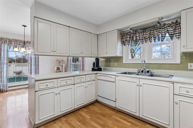 kitchen with sink, white cabinetry, hanging light fixtures, kitchen peninsula, and dishwasher