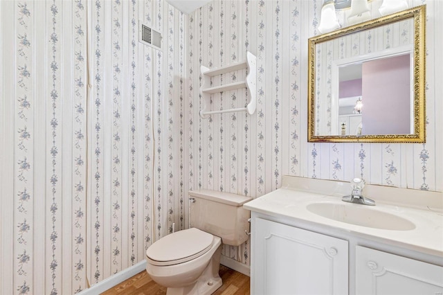 bathroom featuring vanity, hardwood / wood-style flooring, and toilet