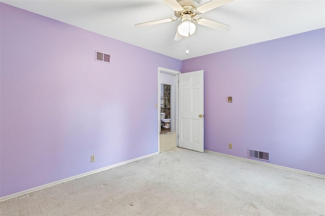 empty room with ceiling fan and light carpet