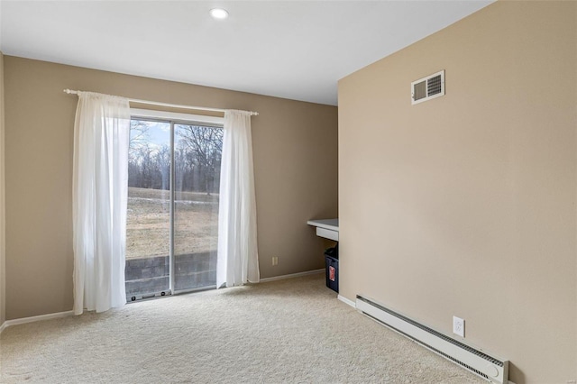 carpeted spare room with a baseboard radiator