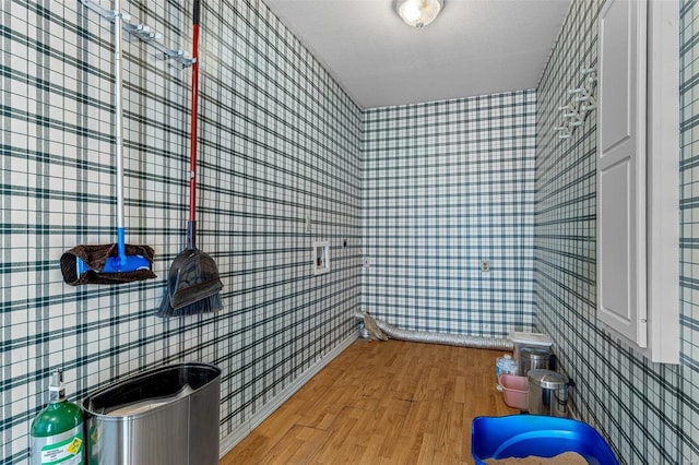 bathroom with wood-type flooring and a textured ceiling