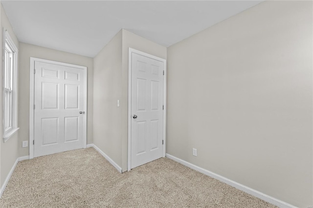 unfurnished bedroom with light colored carpet