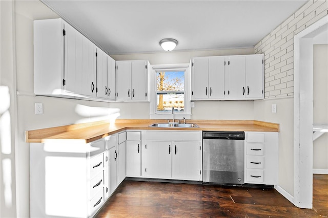 kitchen with white cabinetry, sink, dark wood-type flooring, and stainless steel dishwasher