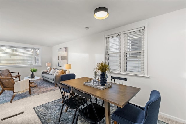 dining room with a wealth of natural light and carpet flooring