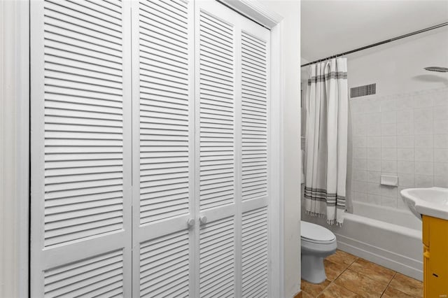 full bathroom with tile patterned floors, toilet, vanity, and shower / tub combo