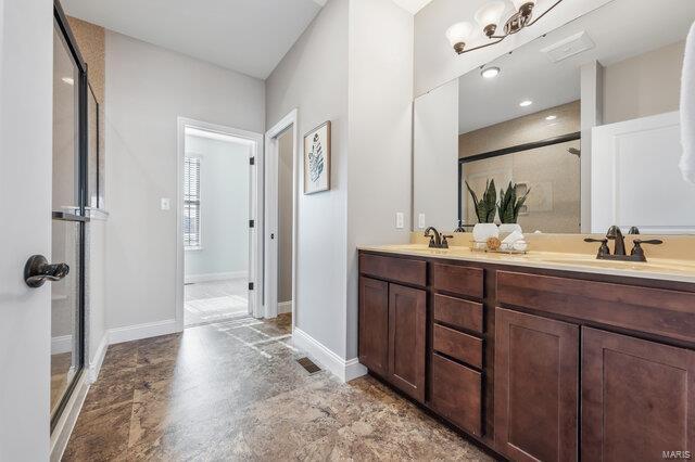 bathroom featuring vanity and a shower with shower door