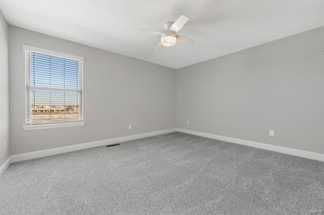 empty room featuring carpet and ceiling fan