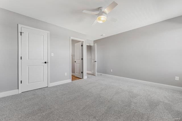 unfurnished bedroom featuring ceiling fan and light colored carpet