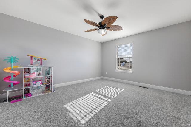 recreation room with ceiling fan and carpet flooring