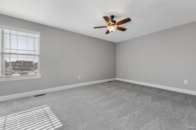 spare room with carpet and ceiling fan