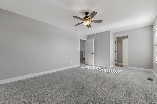 unfurnished bedroom featuring ceiling fan and carpet flooring