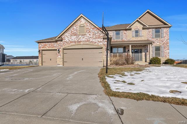 view of front of property featuring a garage and covered porch