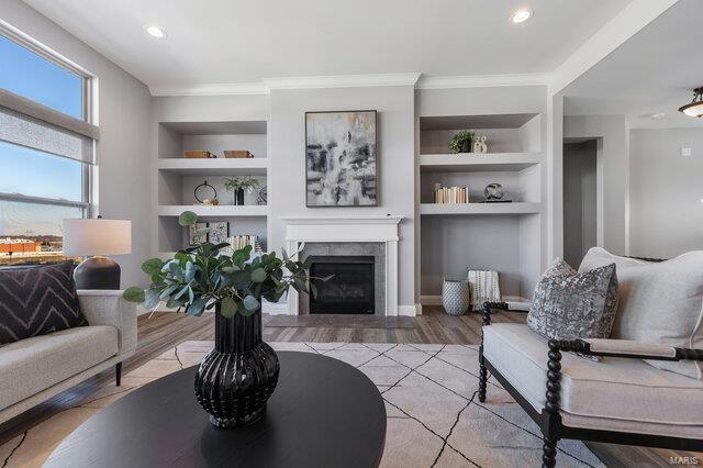 living room with light hardwood / wood-style floors and built in shelves