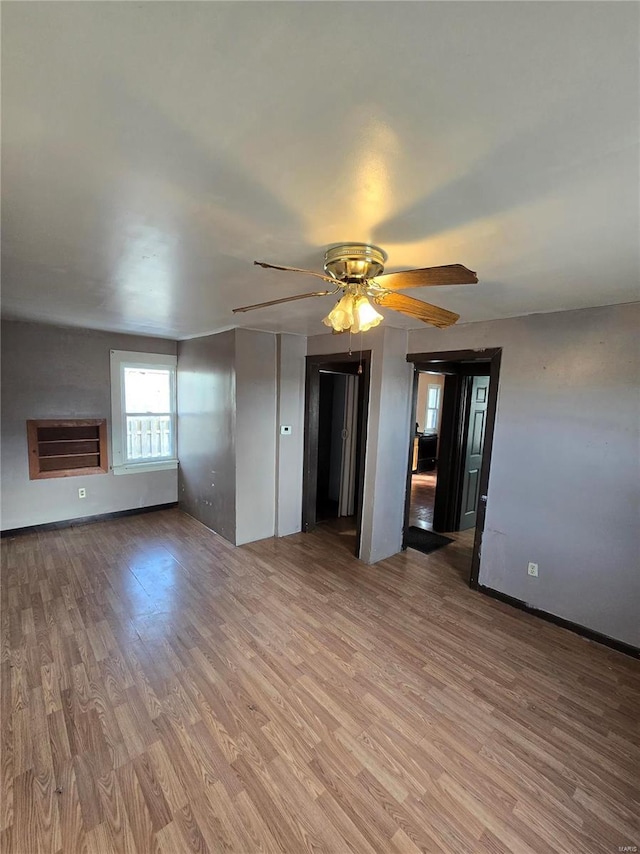 unfurnished room with ceiling fan and light hardwood / wood-style flooring