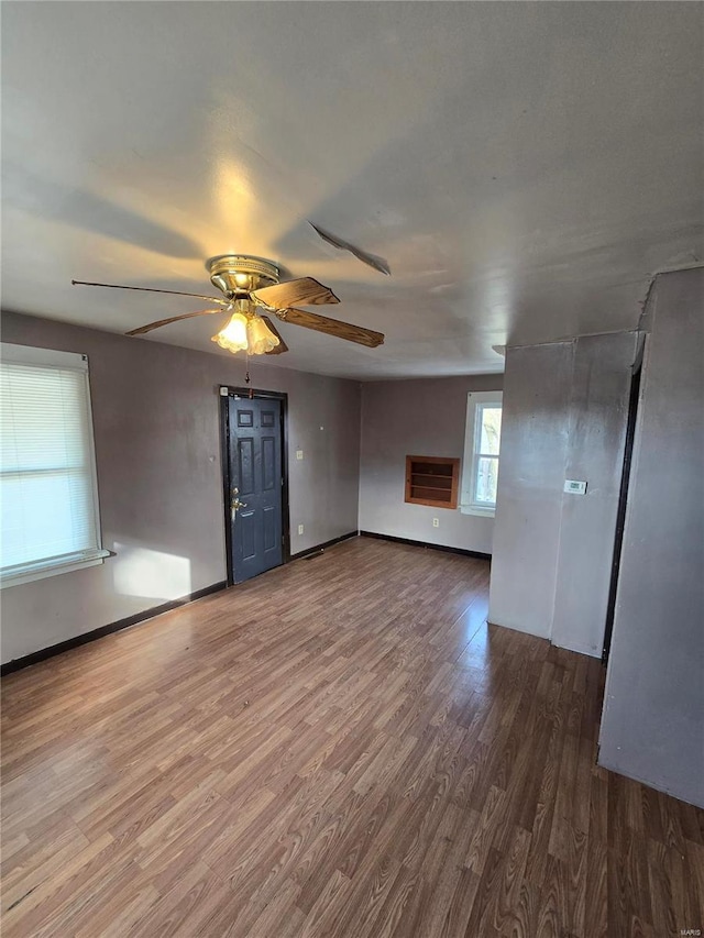 unfurnished living room with ceiling fan and hardwood / wood-style flooring