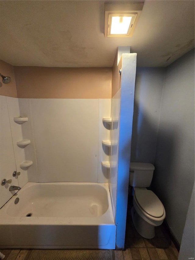 bathroom with shower / tub combination and toilet