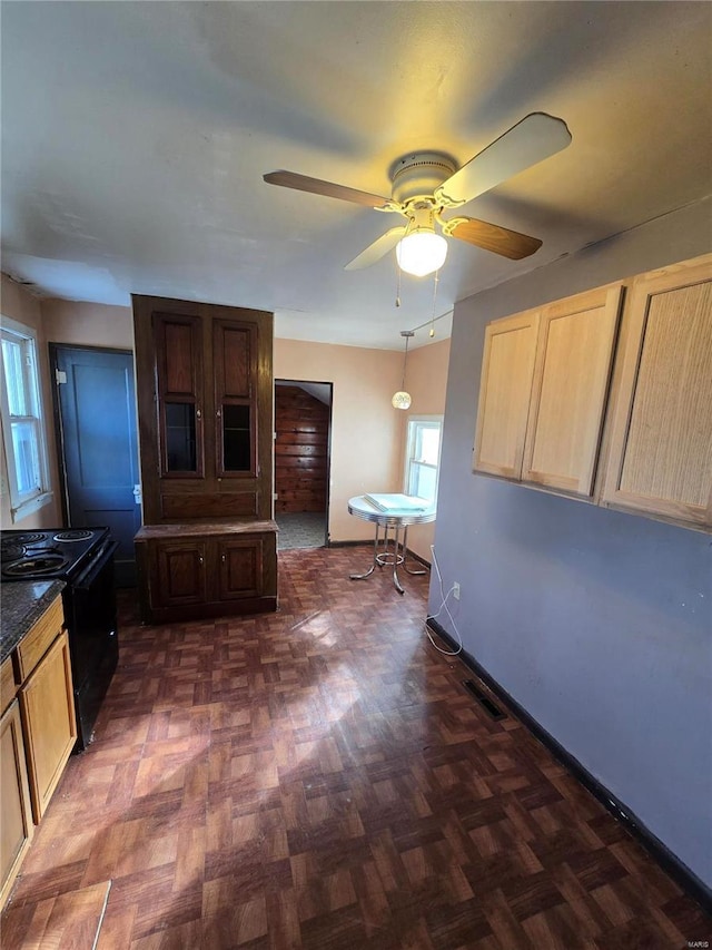 kitchen with ceiling fan, electric range, light brown cabinets, and dark parquet floors