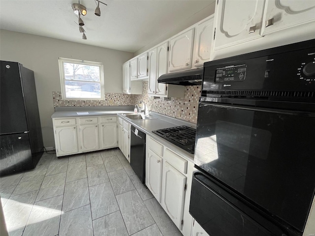 kitchen with under cabinet range hood, white cabinetry, black appliances, and a sink