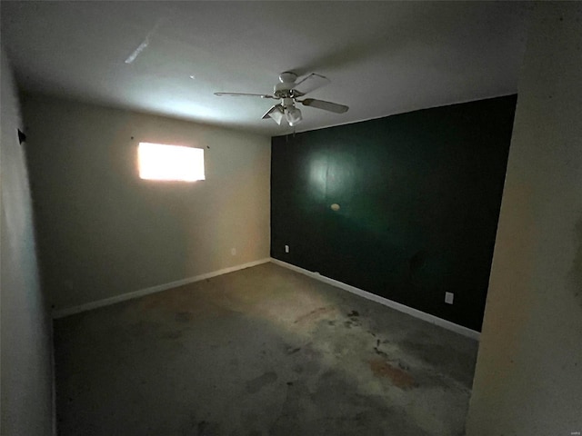 carpeted spare room with baseboards and ceiling fan