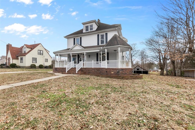 view of front of property with a front yard and covered porch