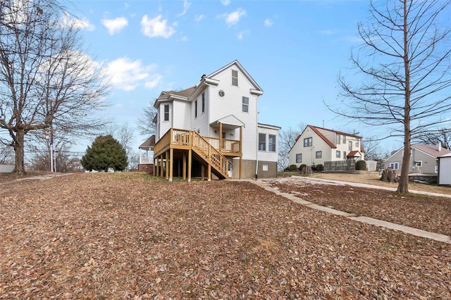 rear view of property with a wooden deck