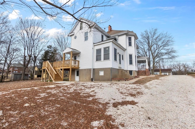 view of side of home with a wooden deck