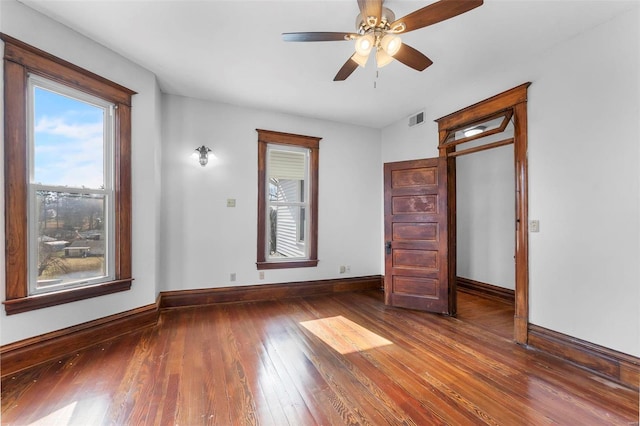 unfurnished bedroom featuring ceiling fan and dark hardwood / wood-style flooring