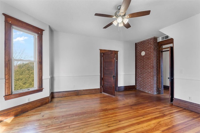 unfurnished room with hardwood / wood-style flooring and ceiling fan