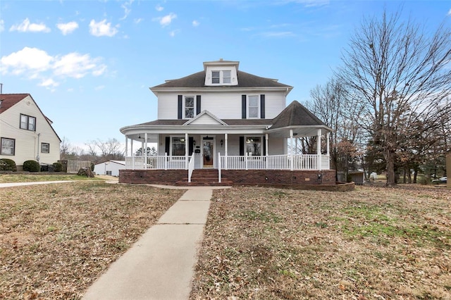 view of front facade featuring a front lawn and covered porch