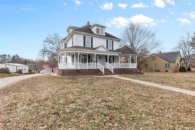 view of front of house featuring a garage, a front lawn, and a porch