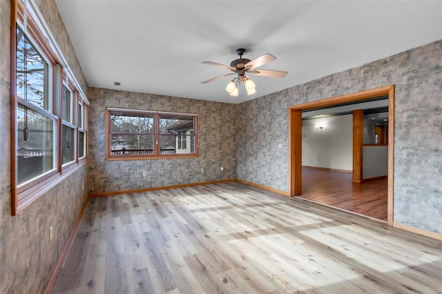 spare room featuring light hardwood / wood-style floors and ceiling fan