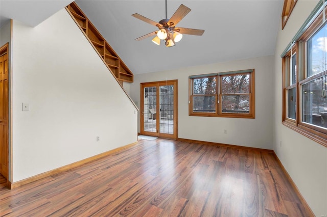 spare room featuring wood-type flooring, high vaulted ceiling, ceiling fan, and french doors