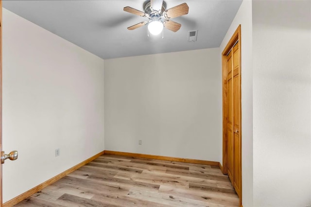 empty room with light wood-type flooring and ceiling fan