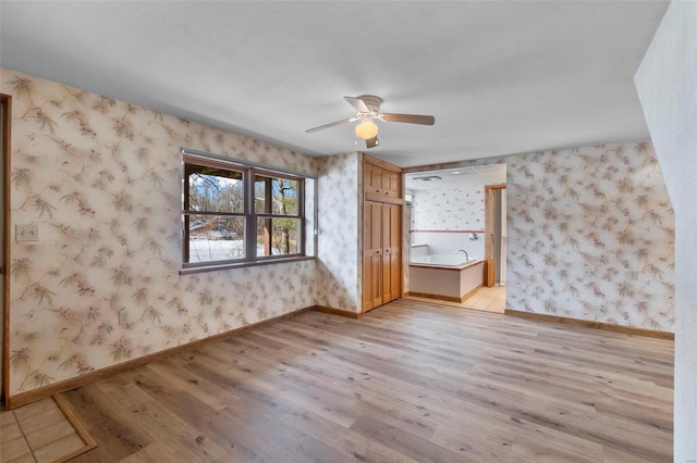 unfurnished bedroom featuring light wood-type flooring and ceiling fan