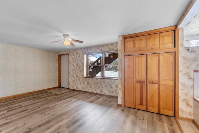 interior space with light wood-type flooring and ceiling fan