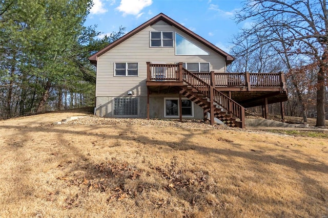 rear view of property with a wooden deck and a yard