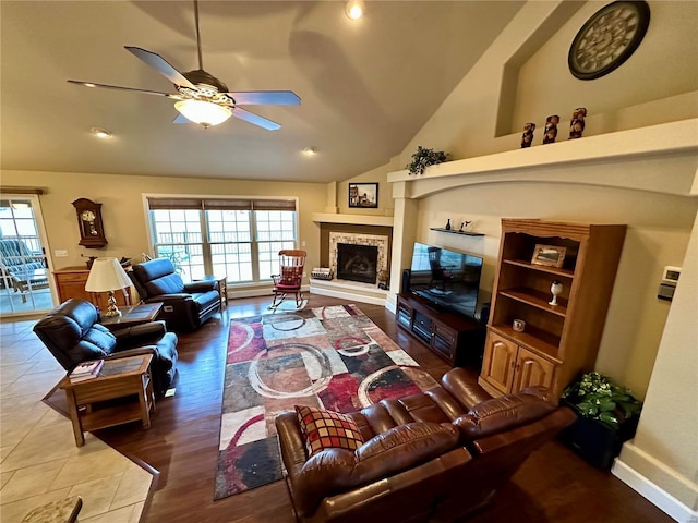 living room featuring vaulted ceiling, a wealth of natural light, and ceiling fan