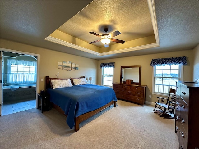 carpeted bedroom with a tray ceiling, a textured ceiling, and ceiling fan