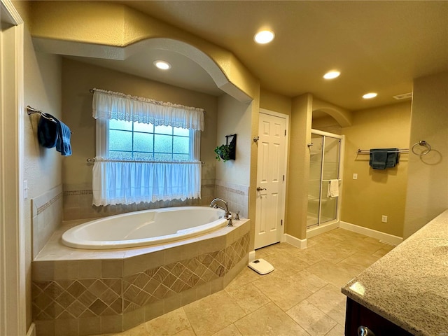 bathroom with vanity, shower with separate bathtub, and tile patterned flooring