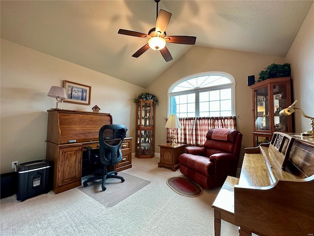 carpeted office space with lofted ceiling and ceiling fan