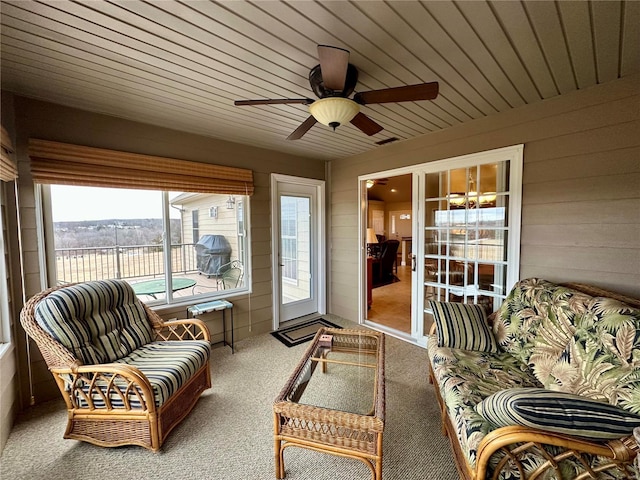 sunroom / solarium with wood ceiling and ceiling fan