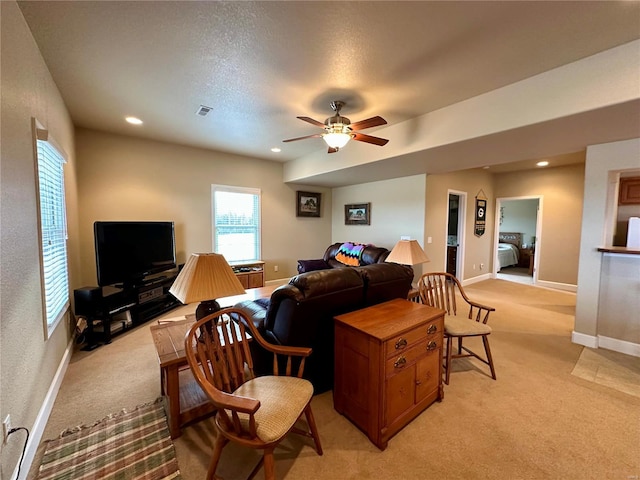 living room with light carpet and ceiling fan